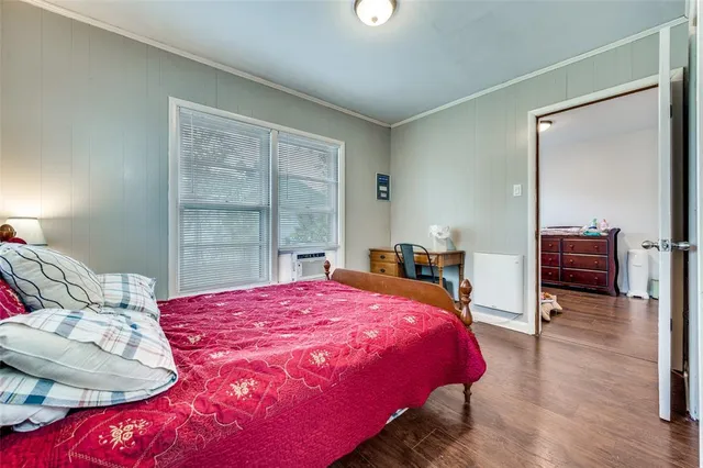 a bedroom with a bed and a television