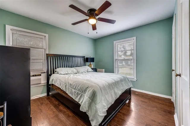 a bedroom with a bed and a ceiling fan