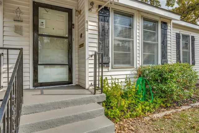a front view of a house with a plants and entryway