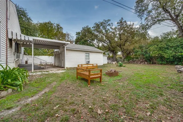a backyard of a house with table and chairs