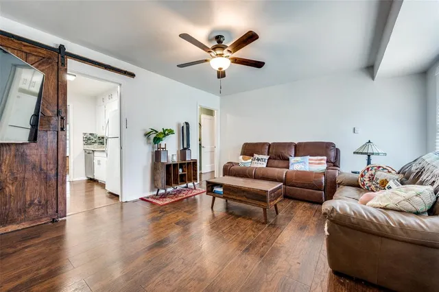a living room with furniture and wooden floor