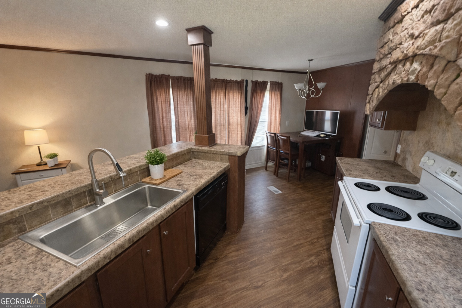 2811 Lyons Center Road Lyons, GA 30436 - Photo 4 of 9 a kitchen with stainless steel appliances granite countertop a sink a stove and a wooden floors