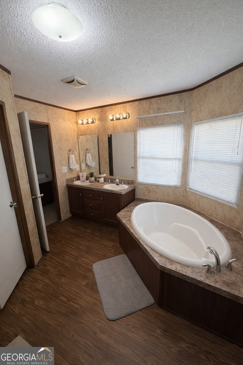 2811 Lyons Center Road Lyons, GA 30436 - Photo 6 of 9 a bathroom with a tub sink and mirror