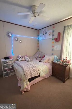 a bedroom with a bed dresser and a window