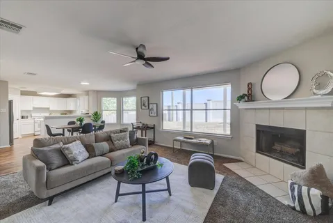 a living room with furniture a fireplace and window