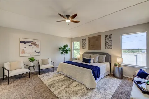 a bedroom with a bed couch and window