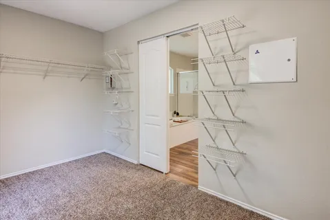 a view of room with ceiling fan and window