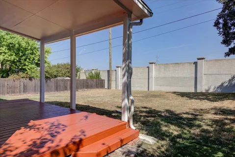 a backyard of a house with table and chairs