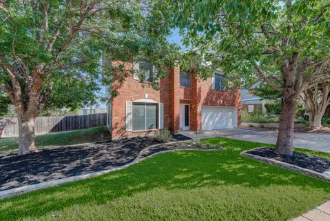 a view of a backyard with table and chairs and a large tree