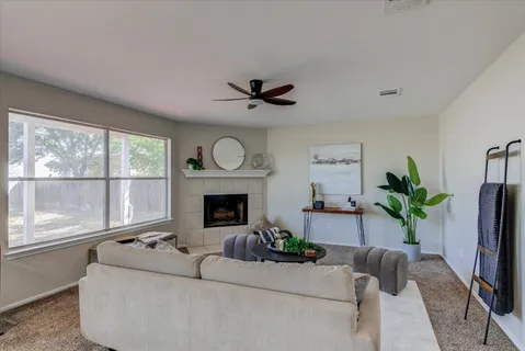 a living room with furniture and a fireplace