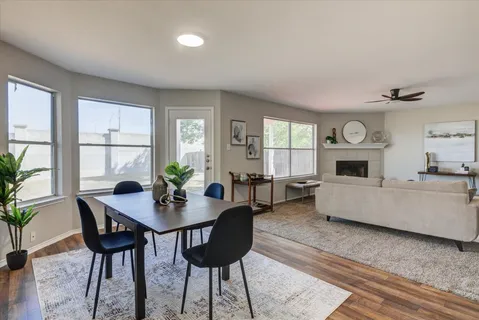 a view of a dining room with furniture and wooden floor