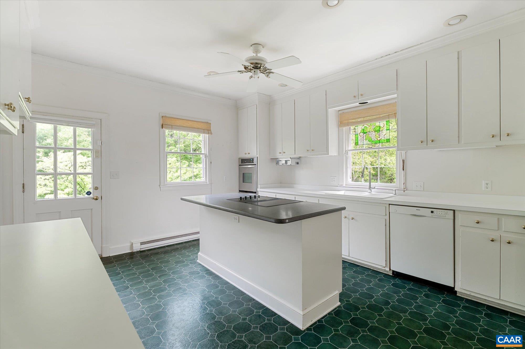 13320 Hackberry Road Orange, VA 22960 - Photo 9 of 47 a kitchen with granite countertop white cabinets and a stove