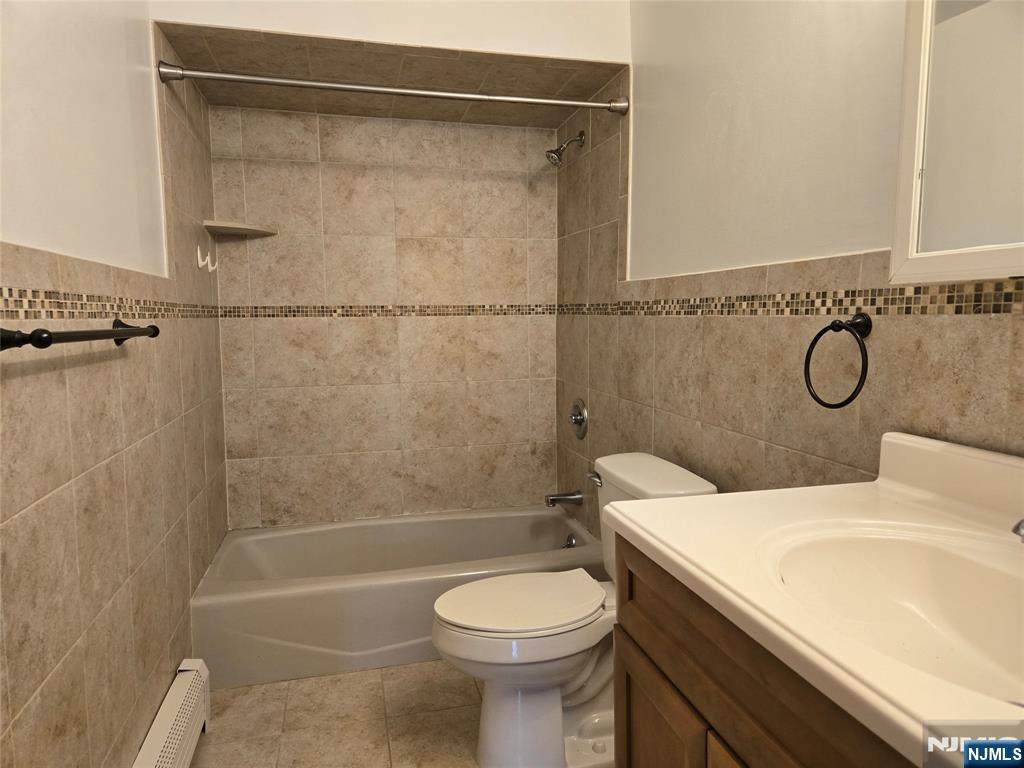 385 Westervelt Place Lodi, NJ 07644 - Photo 8 of 9 a bathroom with a sink a toilet and shower