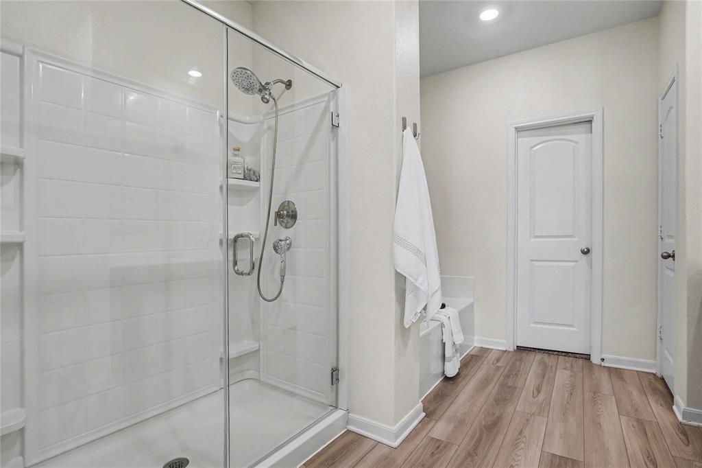 125 Sammy Venus, TX 76084 - Photo 21 of 39 Glass-enclosed shower featuring white subway tile, a multi-function shower head, and a built-in shelving niche