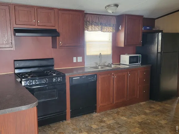a kitchen with stainless steel appliances granite countertop a stove a refrigerator and a sink