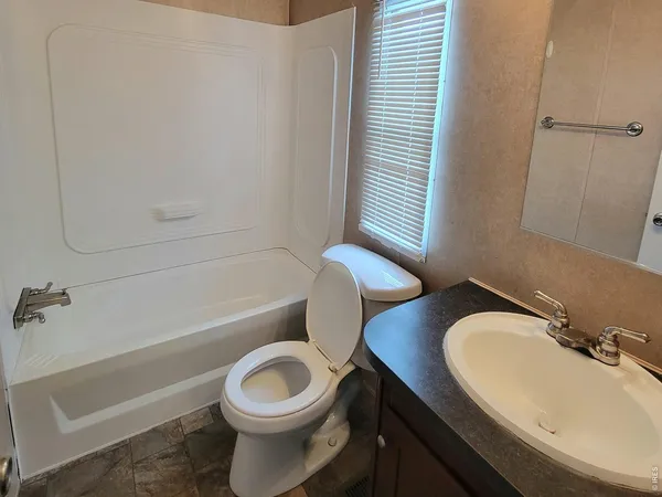 a bathroom with a sink a toilet and tub