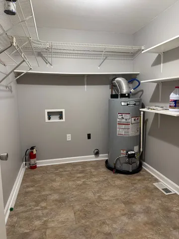 a room with gym equipment and wooden floor