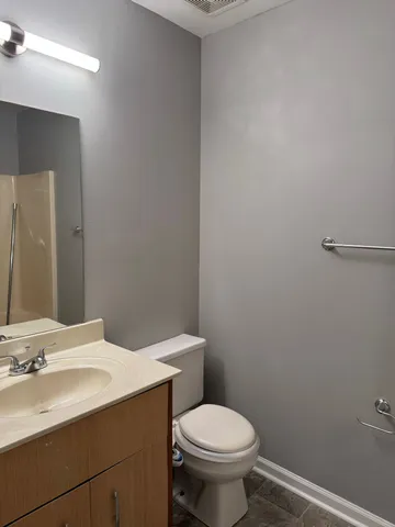 a bathroom with a sink a toilet and mirror