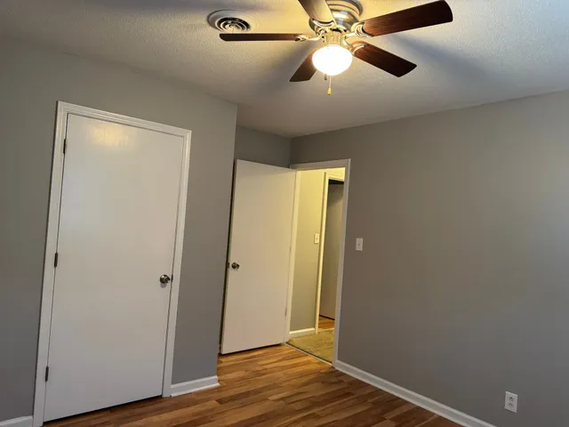 a view of an empty room with wooden floor