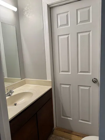 a bathroom with a sink vanity and a mirror