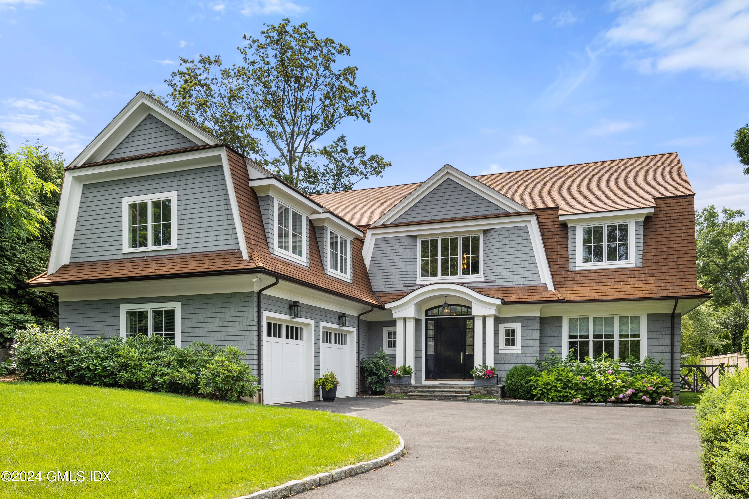 a front view of a house with a garden