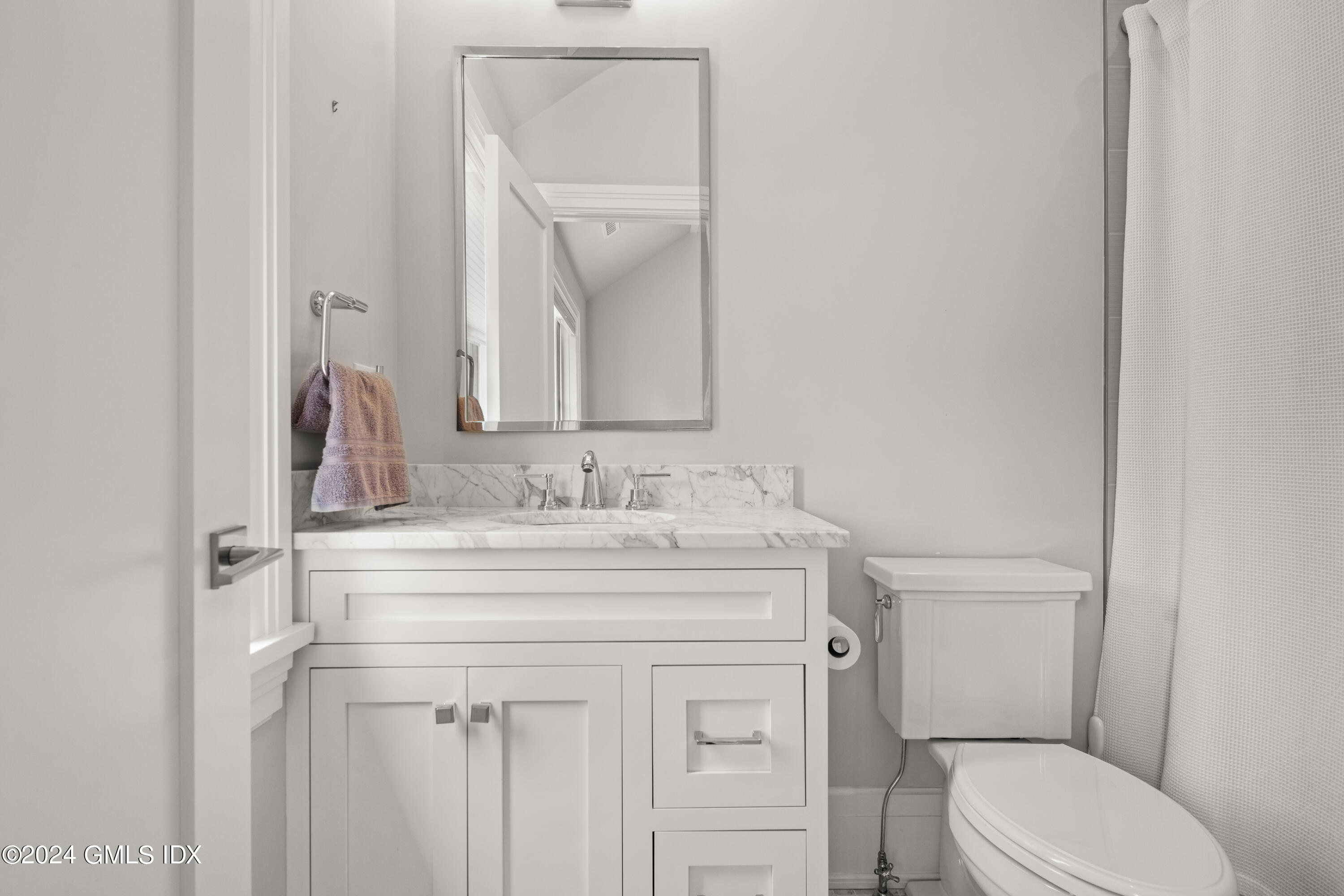 106 Lockwood Road Riverside, CT 06878 - Photo 20 of 38 a bathroom with a sink toilet vanity and mirror