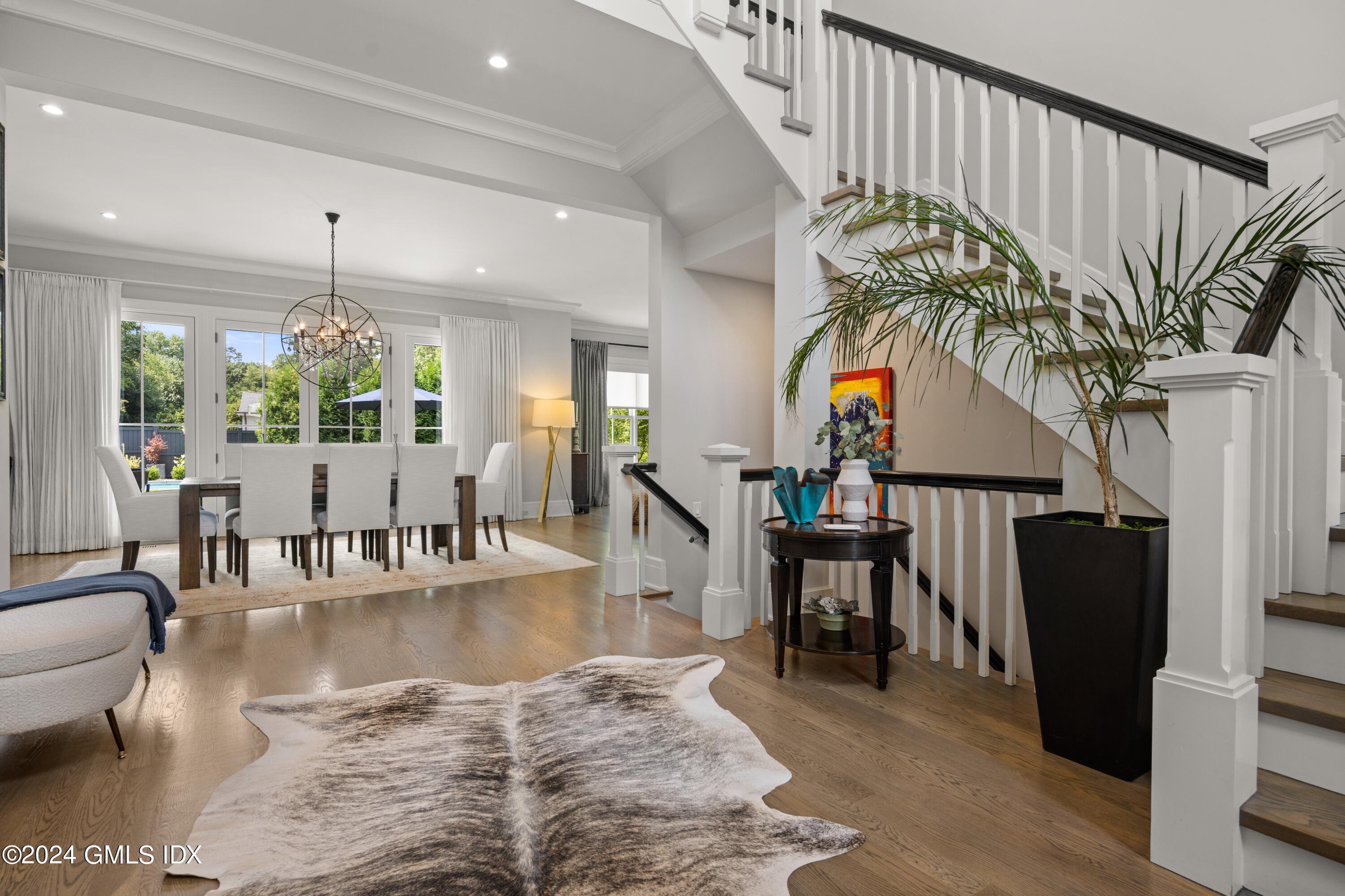 106 Lockwood Road Riverside, CT 06878 - Photo 2 of 38 a living room with furniture dining table and a potted plant