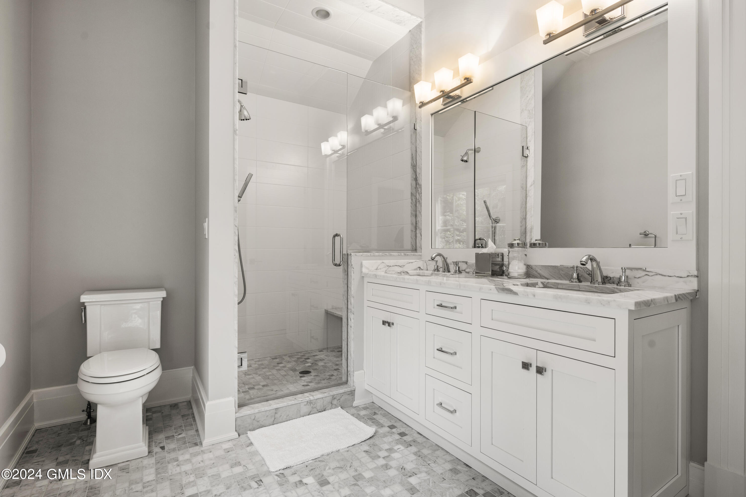 106 Lockwood Road Riverside, CT 06878 - Photo 22 of 38 a bathroom with a granite countertop sink toilet a mirror a vanity and shower