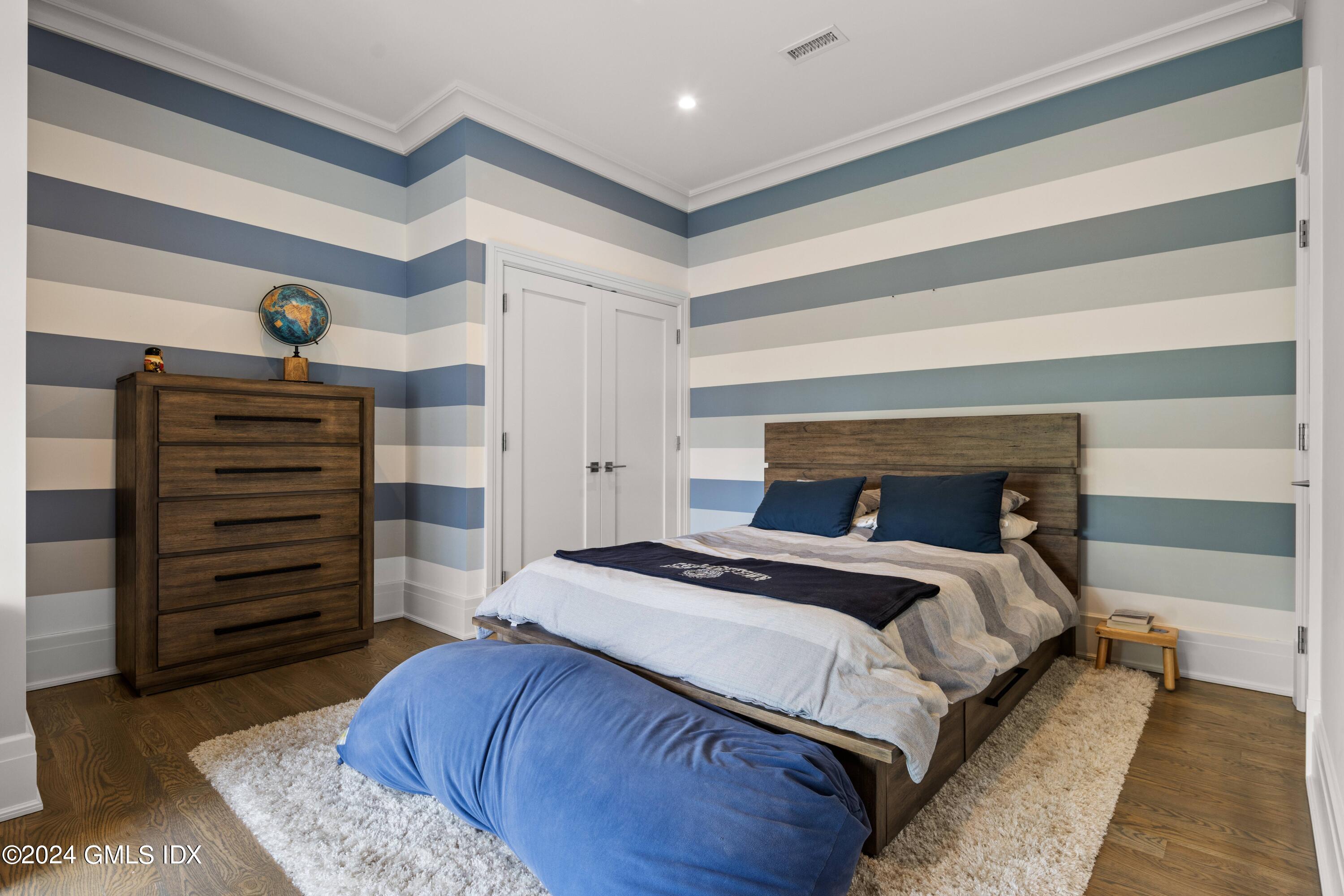 106 Lockwood Road Riverside, CT 06878 - Photo 24 of 38 a bedroom with a bed and wooden floor