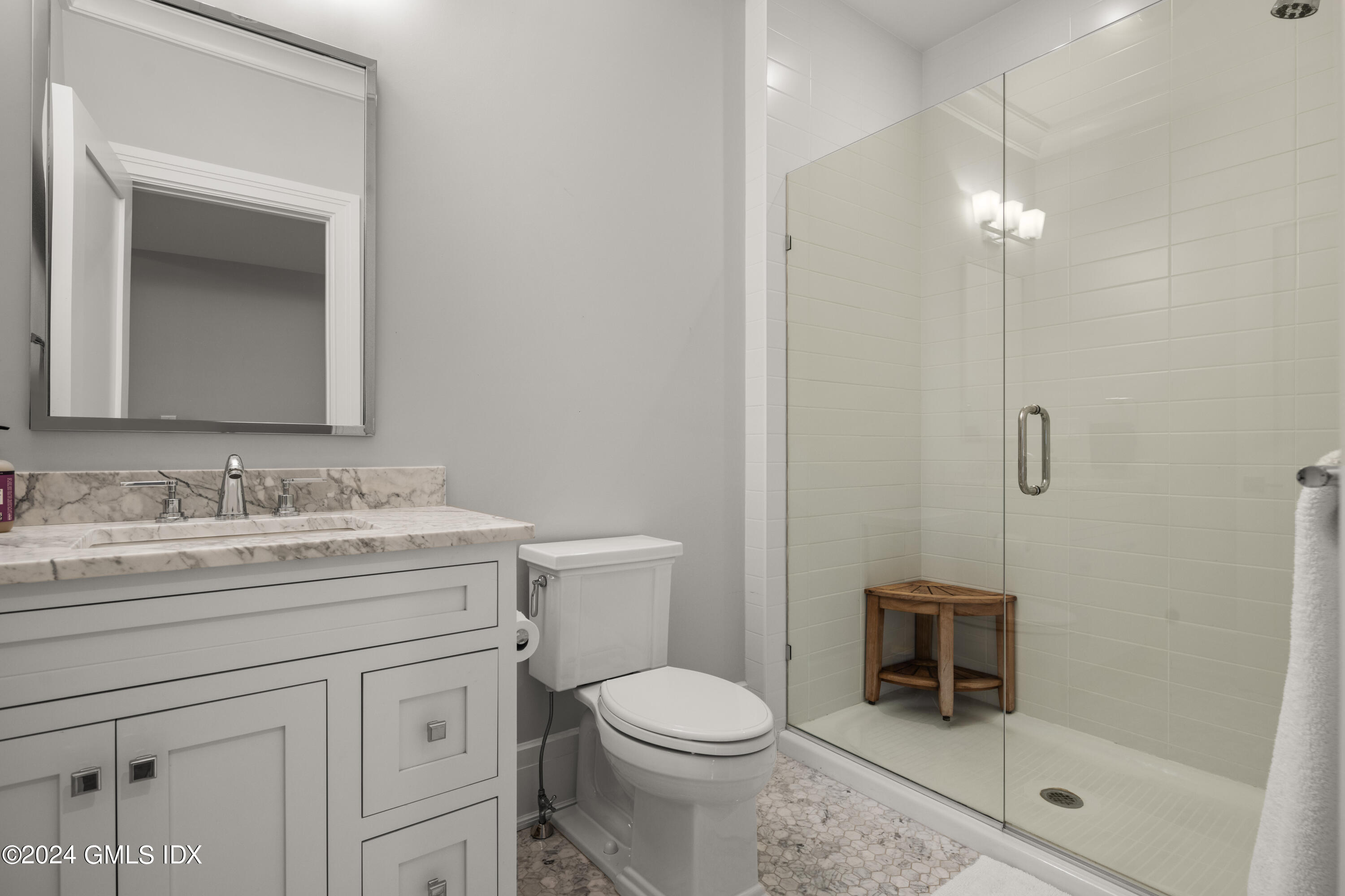 106 Lockwood Road Riverside, CT 06878 - Photo 25 of 38 a bathroom with a granite countertop sink a toilet and shower