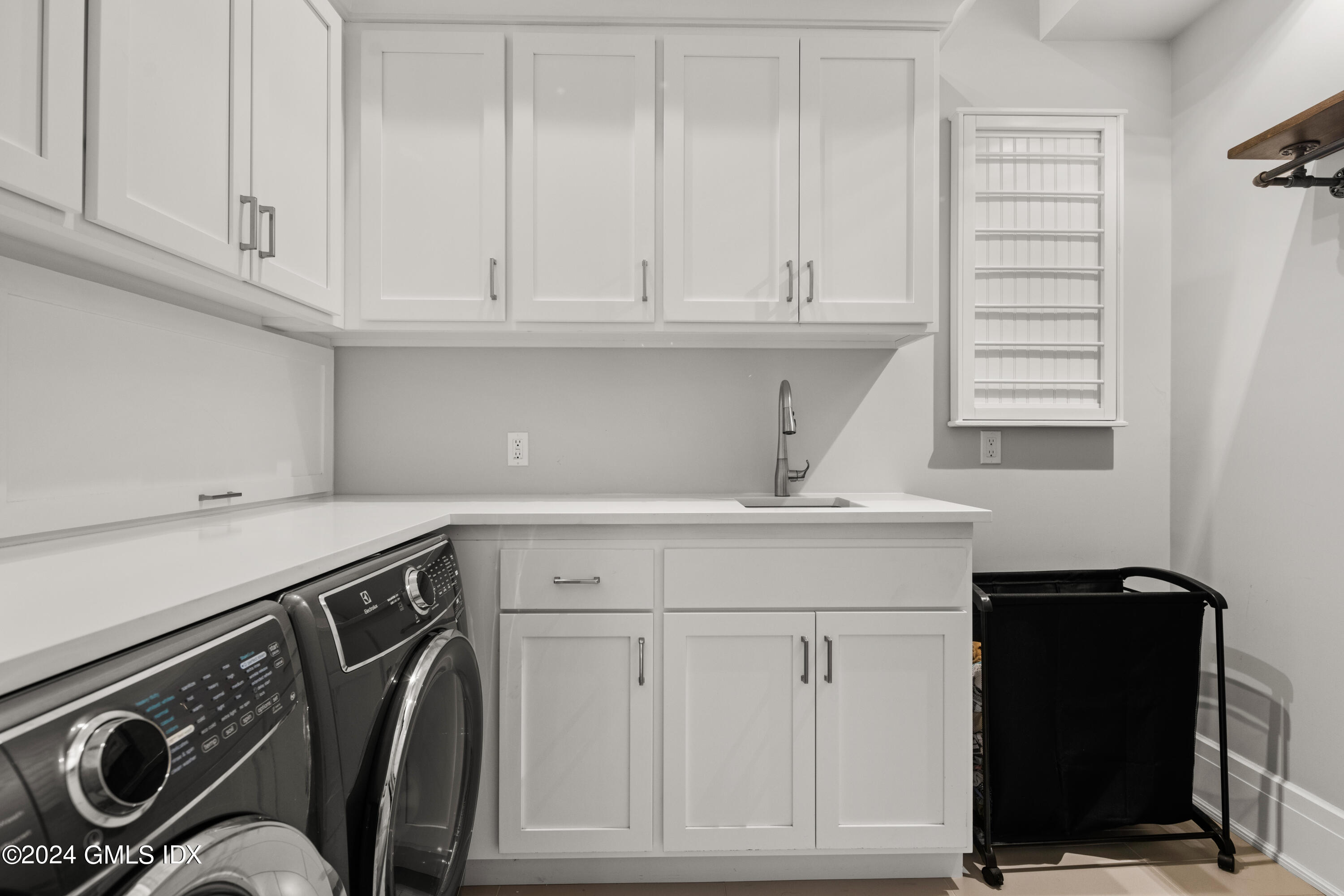 106 Lockwood Road Riverside, CT 06878 - Photo 26 of 38 a view of cabinets with washer and dryer