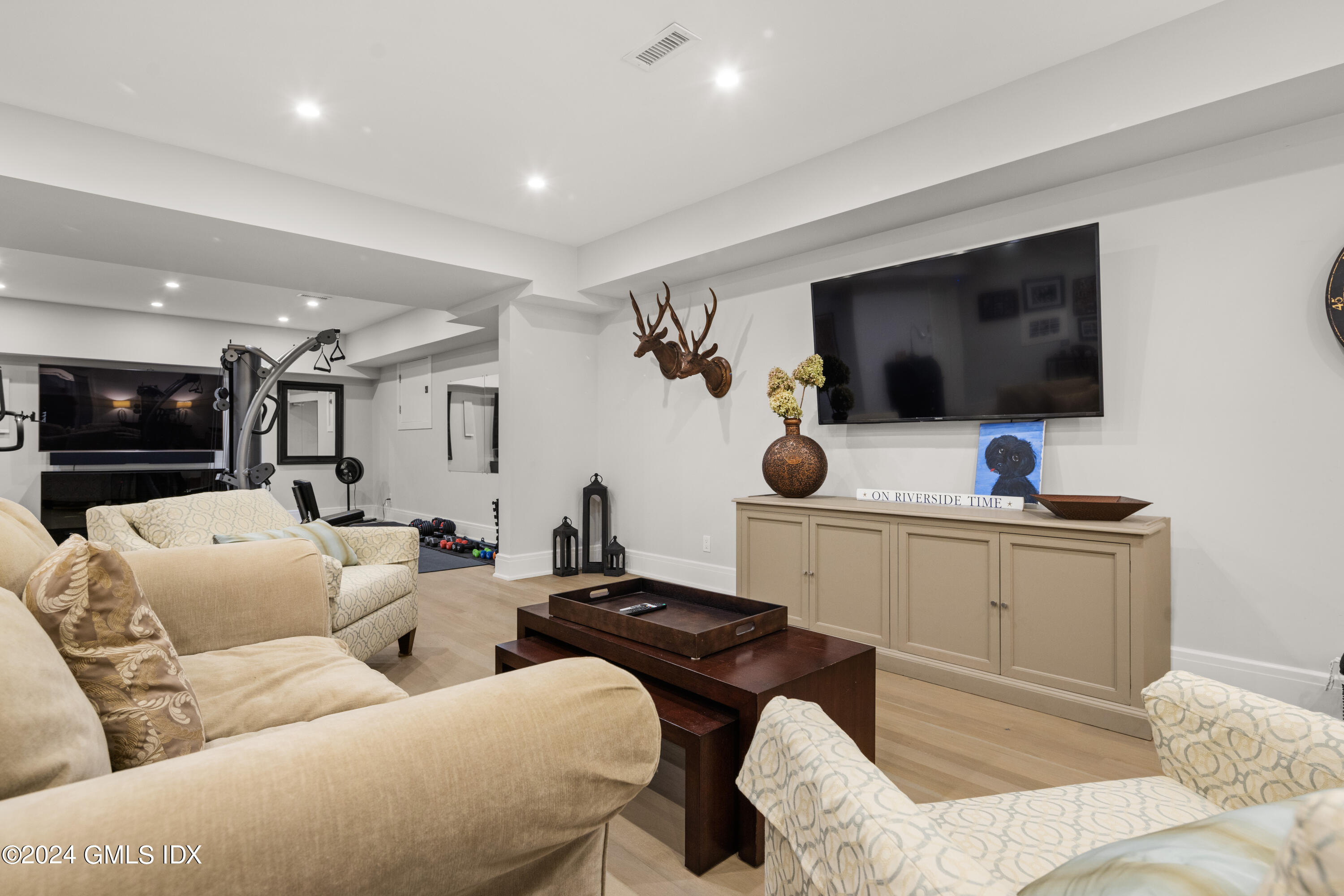 106 Lockwood Road Riverside, CT 06878 - Photo 27 of 38 a living room with furniture and a flat screen tv