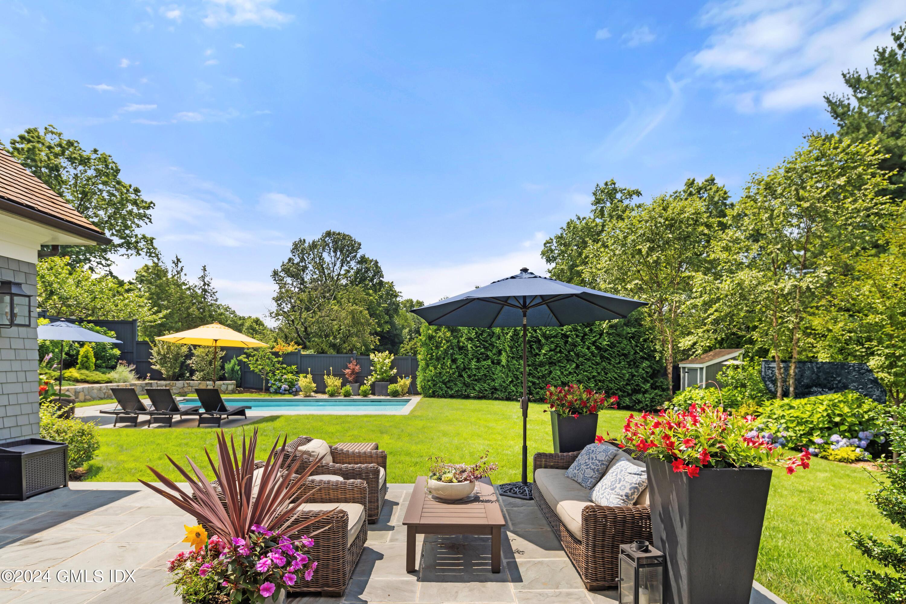 106 Lockwood Road Riverside, CT 06878 - Photo 33 of 38 a view of a swimming pool with couches in patio