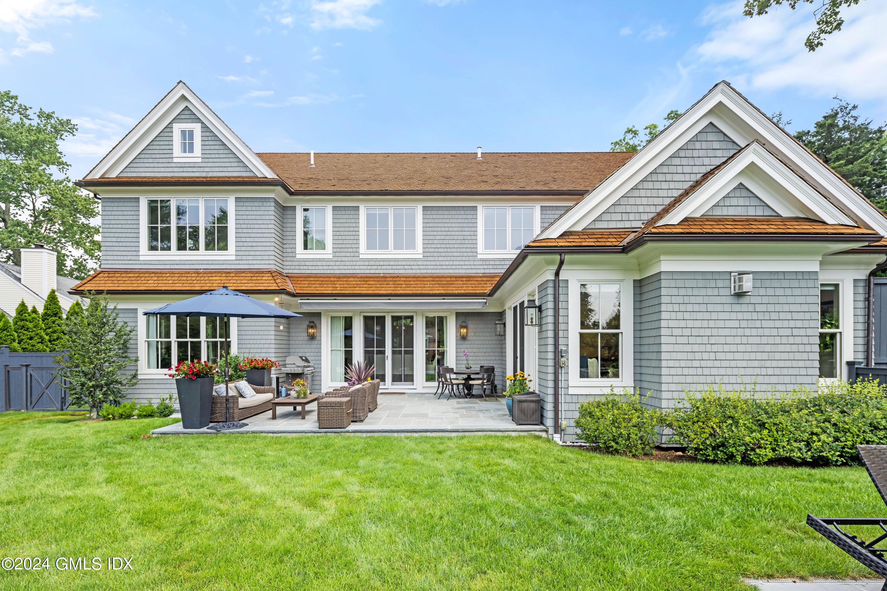 106 Lockwood Road Riverside, CT 06878 - Photo 34 of 38 a front view of a house with swimming pool and porch