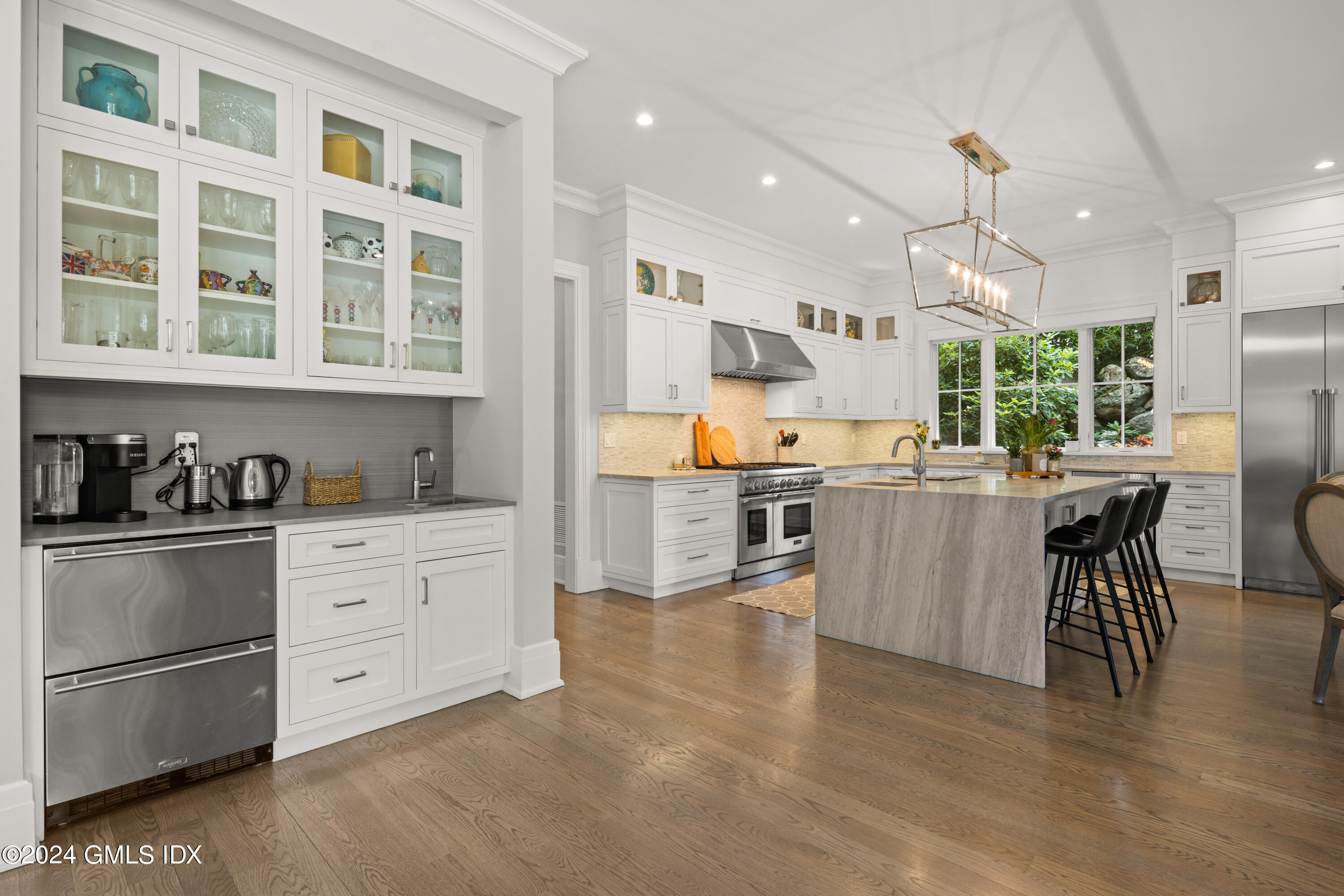 106 Lockwood Road Riverside, CT 06878 - Photo 4 of 38 a kitchen with stainless steel appliances granite countertop a refrigerator a sink dishwasher a dining table and chairs with wooden floor