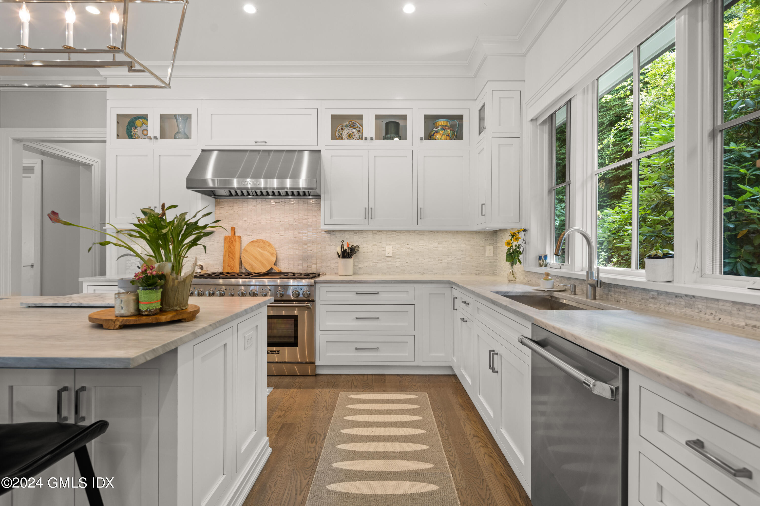 106 Lockwood Road Riverside, CT 06878 - Photo 6 of 38 a kitchen with white cabinets and window