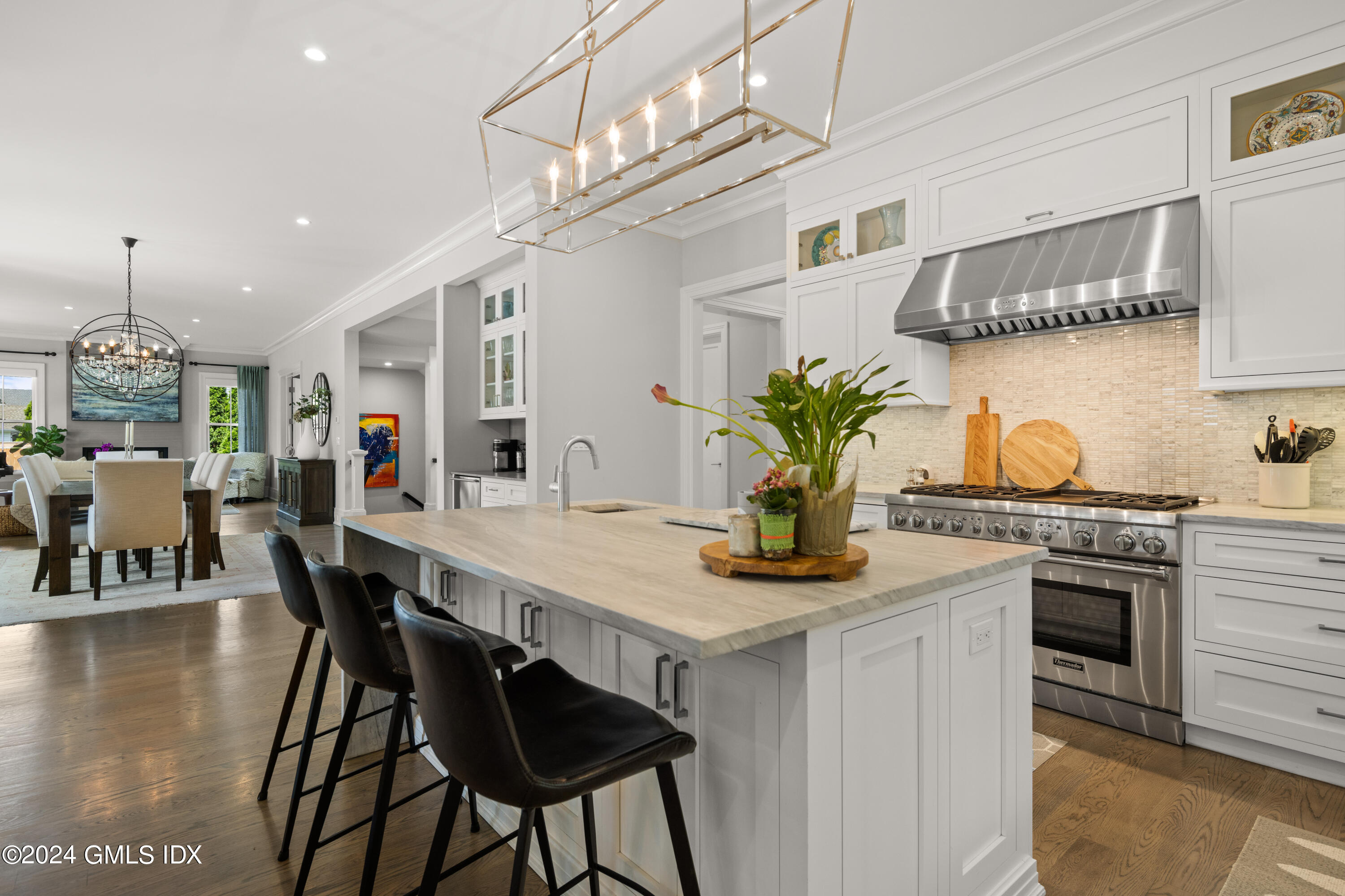 106 Lockwood Road Riverside, CT 06878 - Photo 7 of 38 a kitchen with stainless steel appliances kitchen island a table and chairs in it