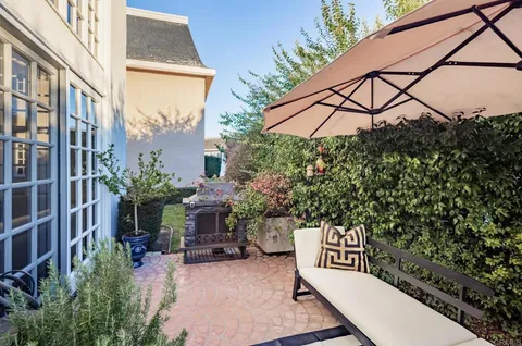 a view of a patio with table and chairs and potted plants