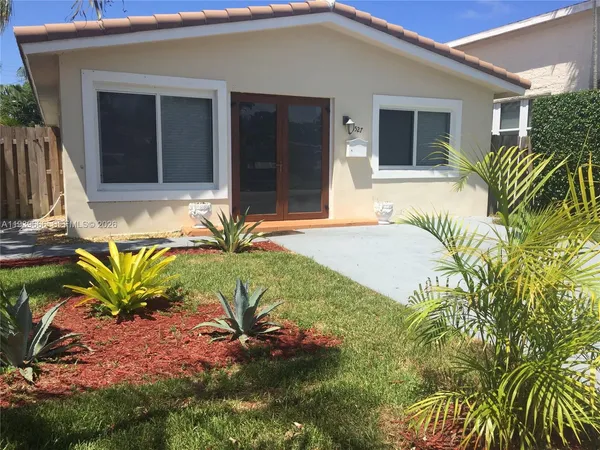 a view of house with backyard and outdoor seating