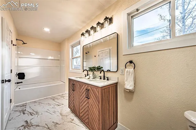 a bathroom with a sink a mirror and a bathtub