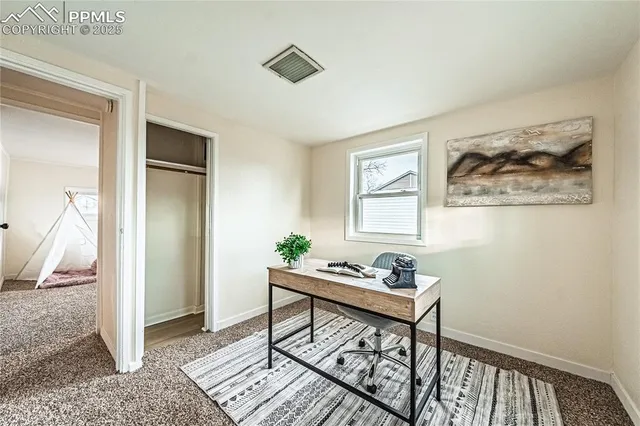 a workspace with wooden floor and a bedroom