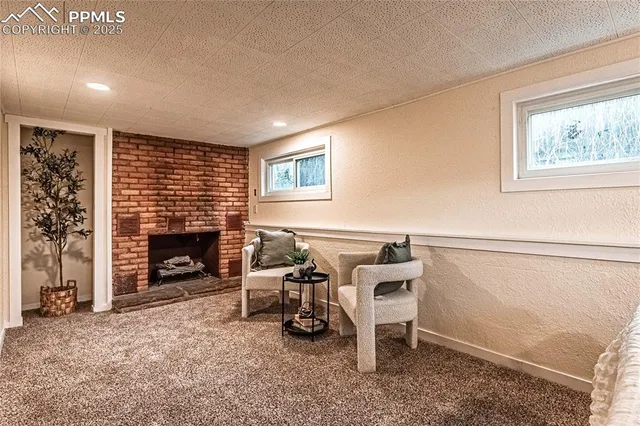 a view of a livingroom with furniture and a fireplace