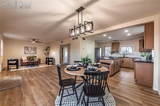 a view of a dining room with furniture window and wooden floor