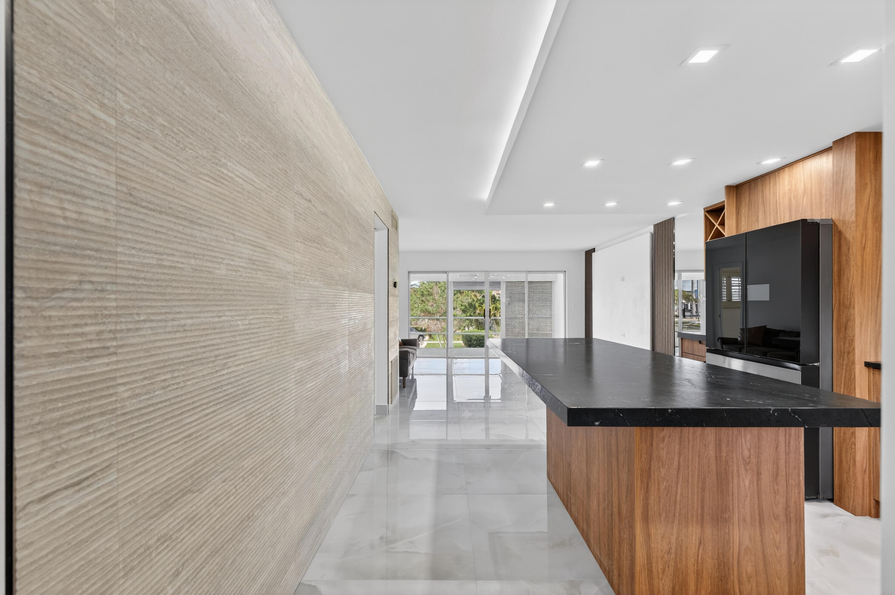 2134 Northeast 36th Street, Unit 82 Lighthouse Point, FL 33064 - Photo 11 of 38 a kitchen with stainless steel appliances granite countertop a sink a microwave counter space and cabinets