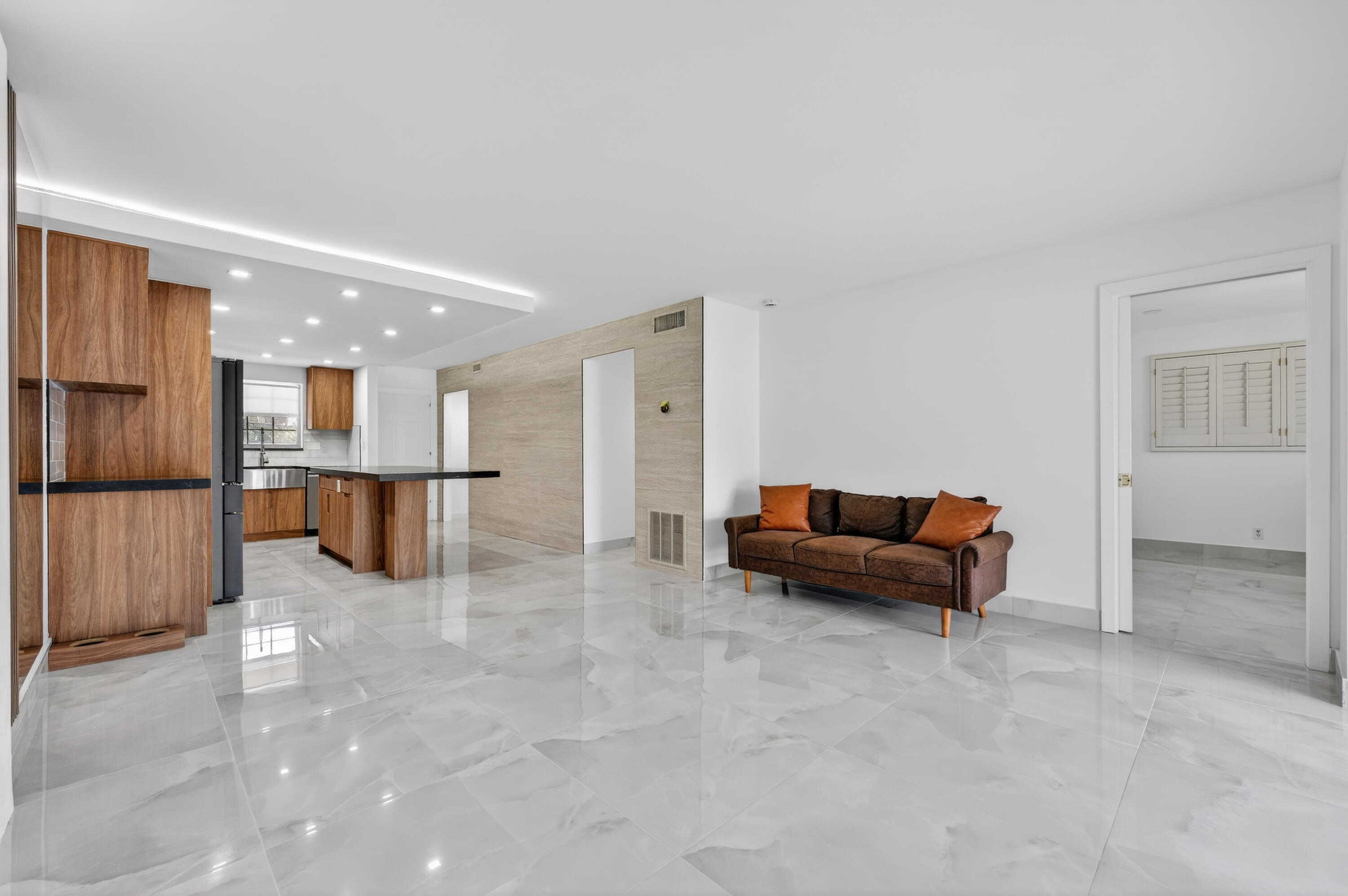 2134 Northeast 36th Street, Unit 82 Lighthouse Point, FL 33064 - Photo 12 of 38 a living room with furniture and kitchen view