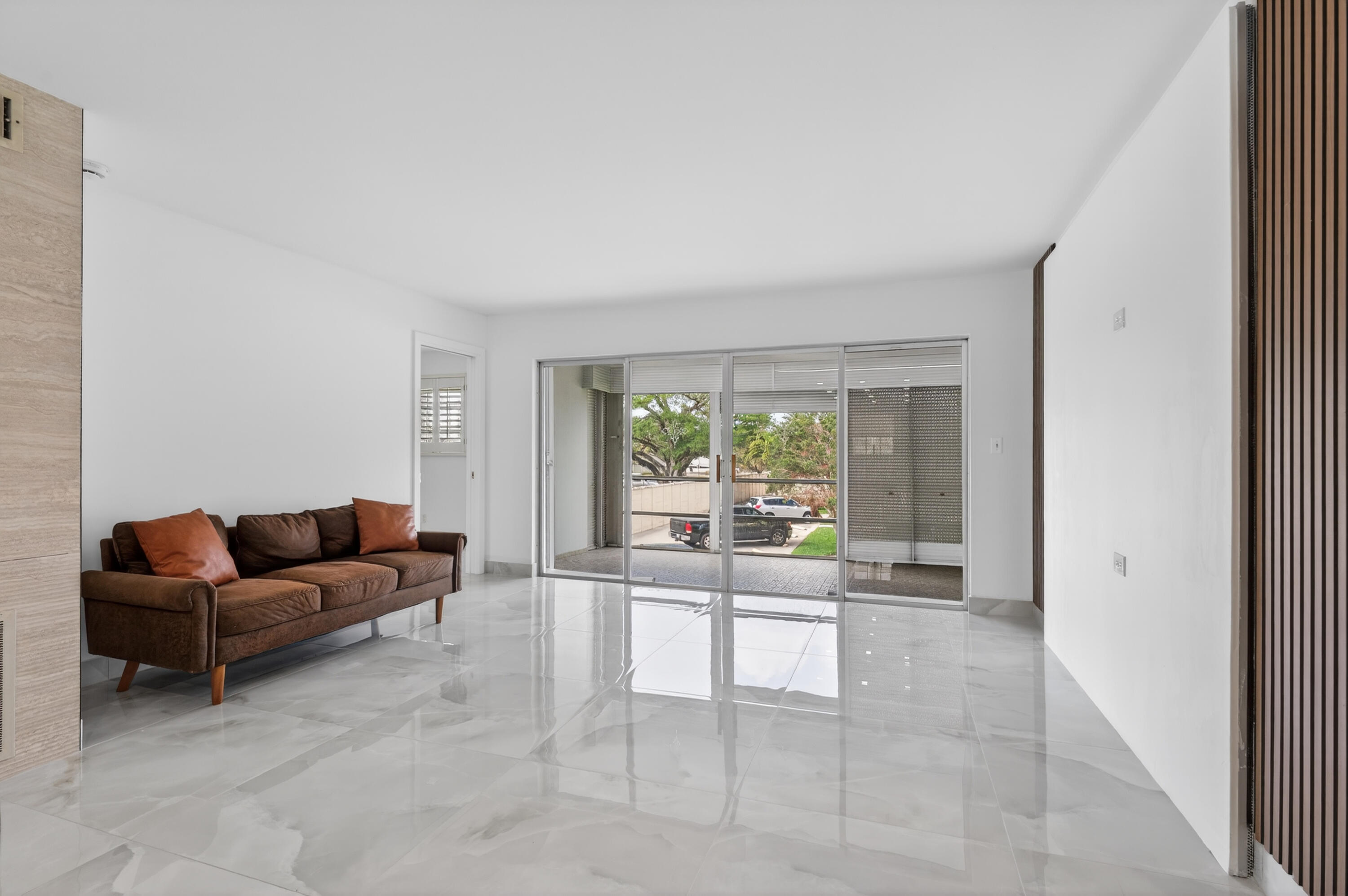 2134 Northeast 36th Street, Unit 82 Lighthouse Point, FL 33064 - Photo 14 of 38 a living room with furniture and a large window