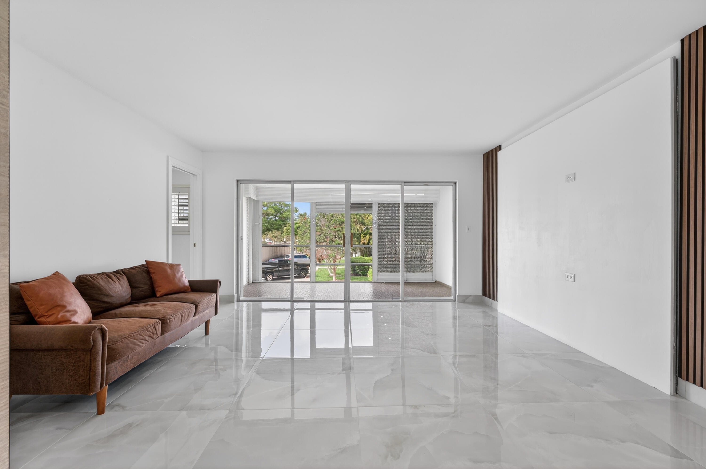 2134 Northeast 36th Street, Unit 82 Lighthouse Point, FL 33064 - Photo 15 of 38 a living room with furniture and a large window