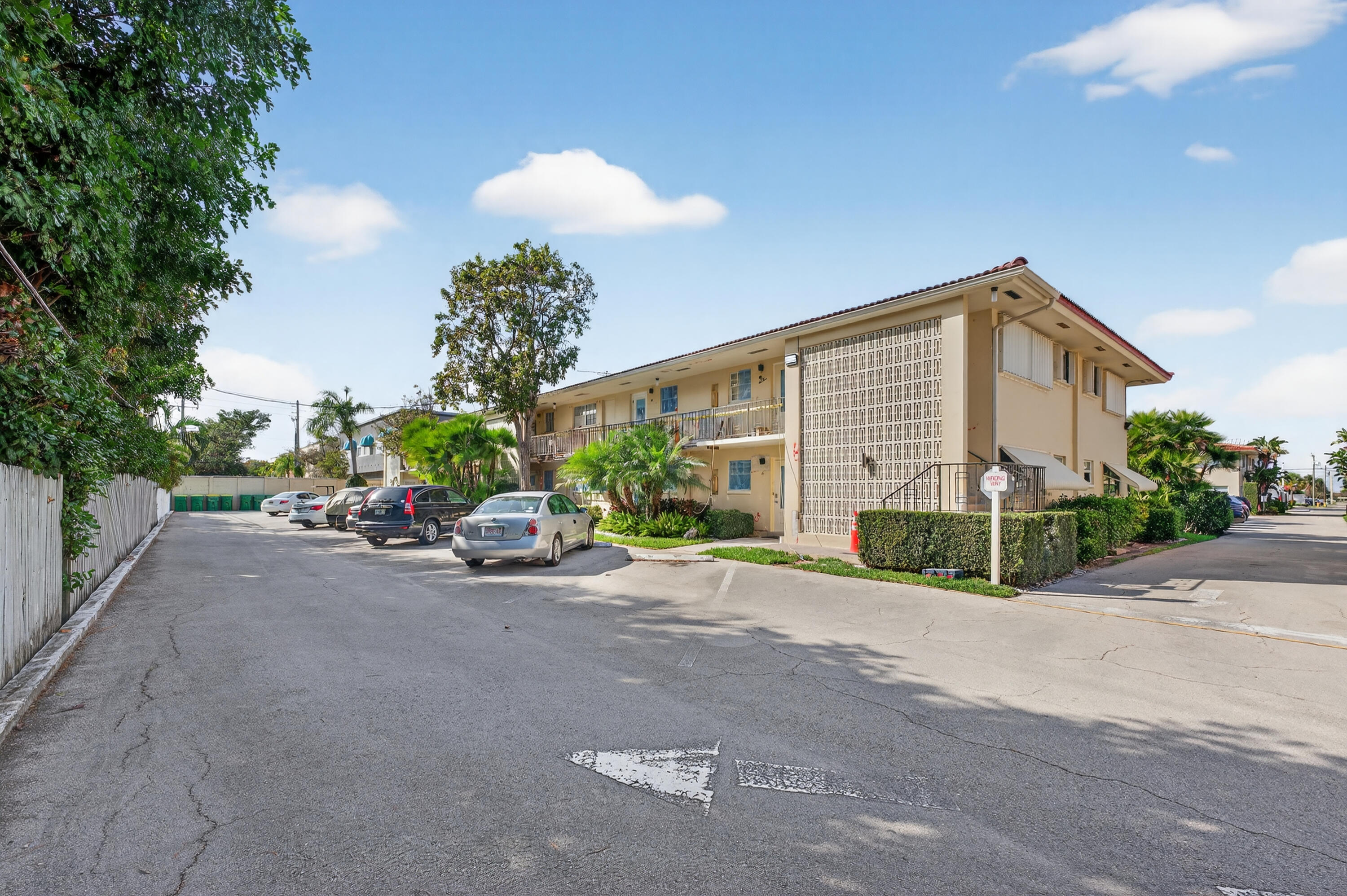 2134 Northeast 36th Street, Unit 82 Lighthouse Point, FL 33064 - Photo 2 of 38 a view of a house with porch and a car parked beside of it