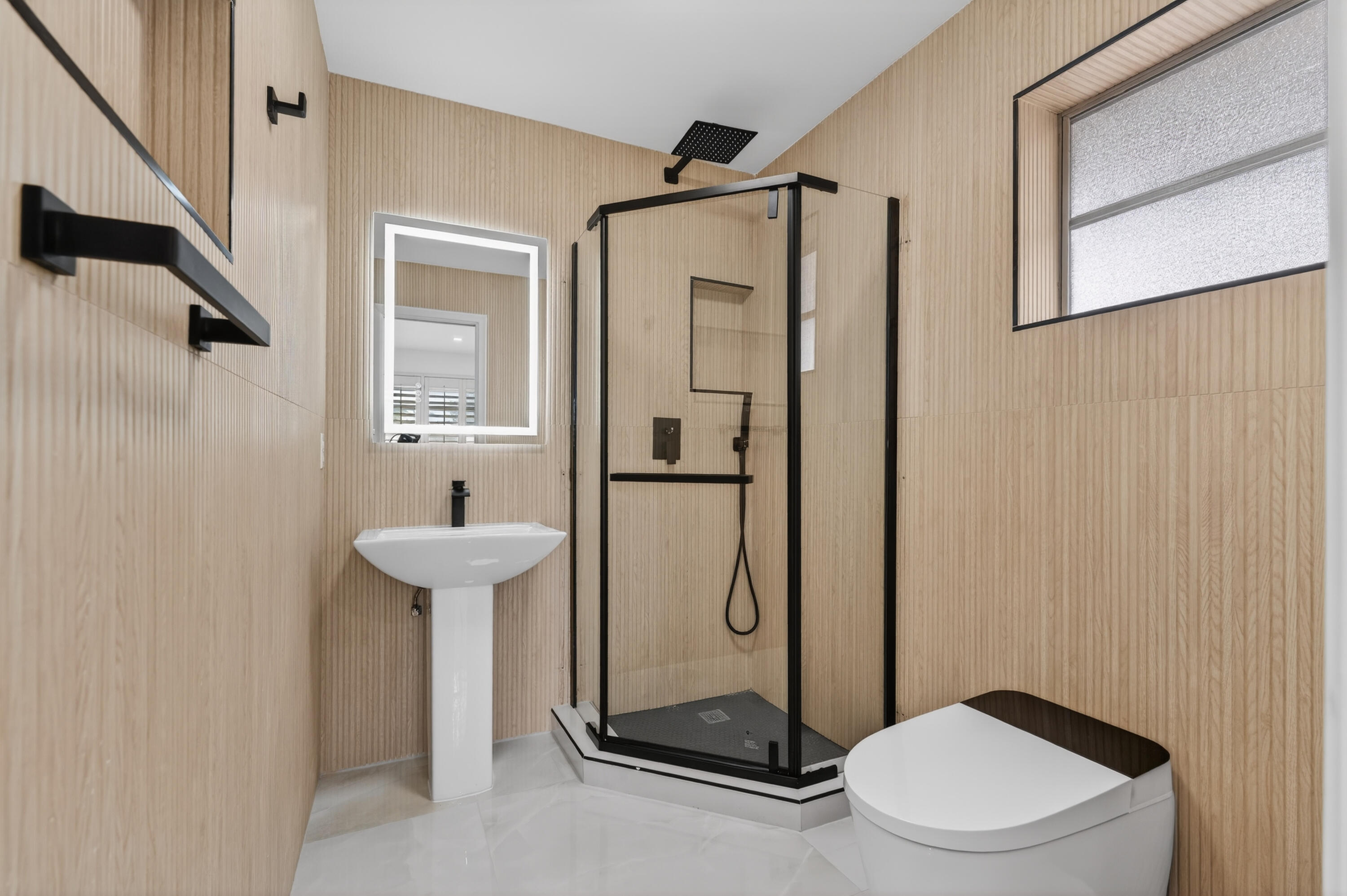 2134 Northeast 36th Street, Unit 82 Lighthouse Point, FL 33064 - Photo 21 of 38 a bathroom with a shower toilet and sink