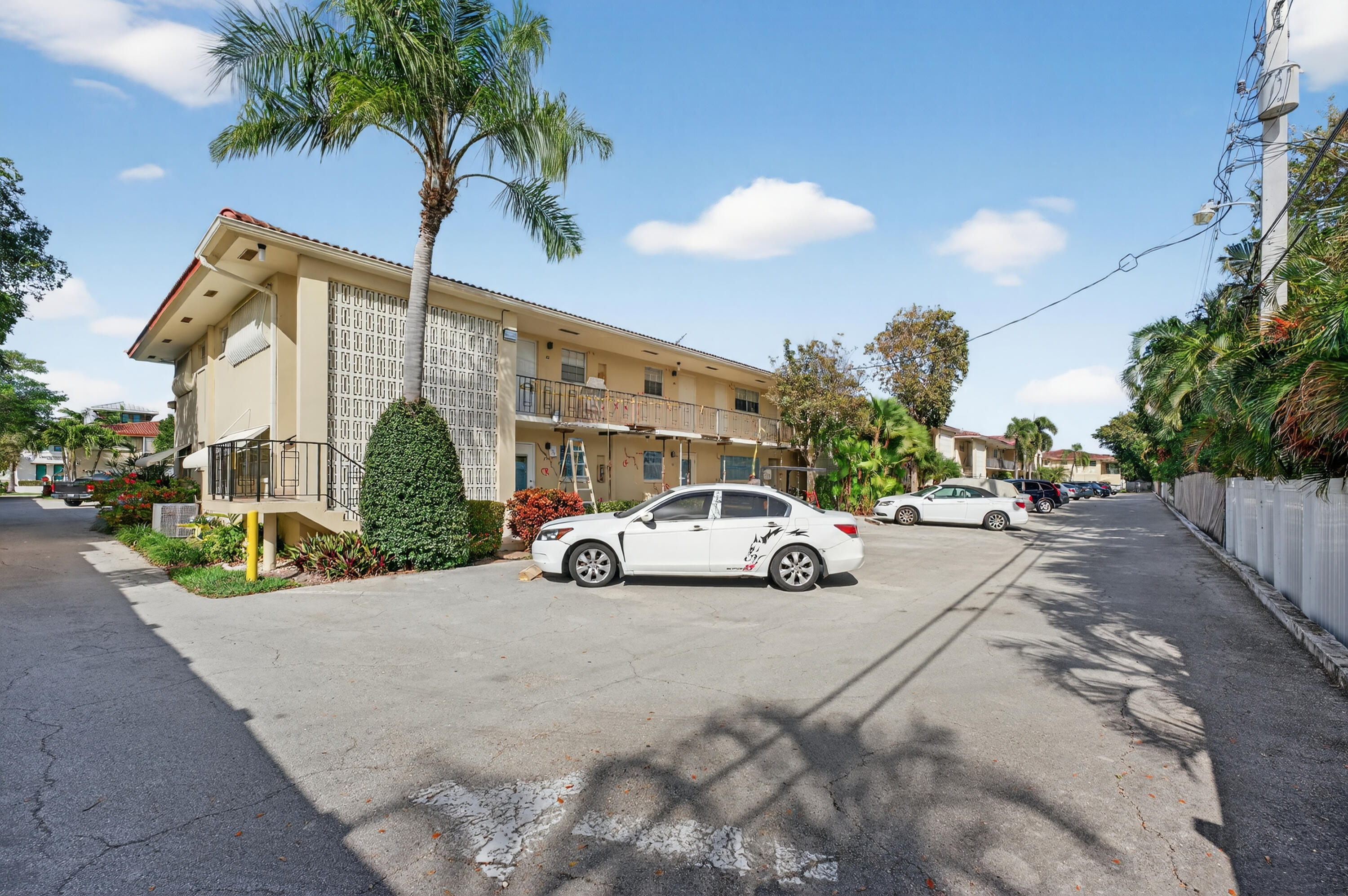 2134 Northeast 36th Street, Unit 82 Lighthouse Point, FL 33064 - Photo 3 of 38 a view of street with parked cars